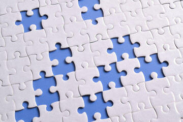 White puzzle with missing piece on blue background, top view
