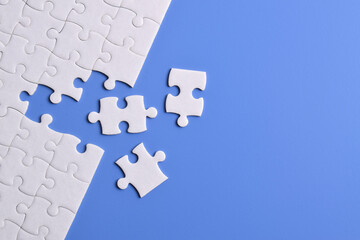 White puzzle with missing piece on blue background. Flat lay. Top view