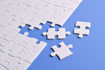 White puzzle with missing piece on blue background. Flat lay. Top view