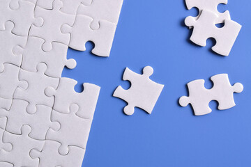 White puzzle with missing piece on blue background. Flat lay. Top view