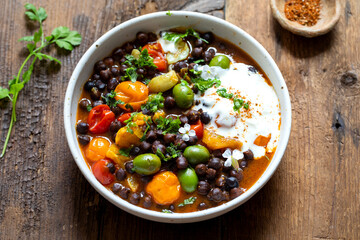 Black chickpeas stew with nocellara olives, tomatoes and orange