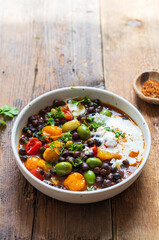 Black chickpeas stew with nocellara olives, tomatoes and orange