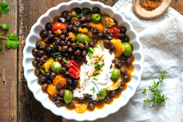 Black chickpeas stew with nocellara olives, tomatoes and orange