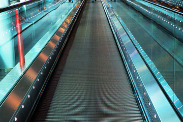 Empty moving walkway in an international airport. Travelator with perspective lines
