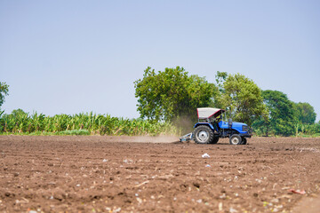 tractor working in the agricultural empty field