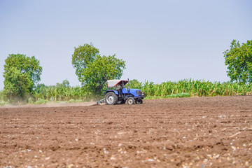 tractor working in the agricultural empty field