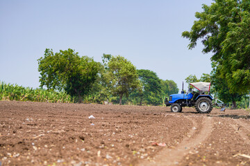 tractor working in the agricultural empty field
