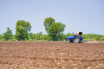 tractor working in the agricultural empty field