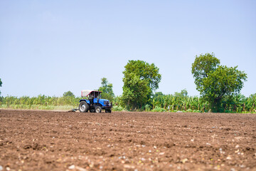 tractor working in the agricultural empty field