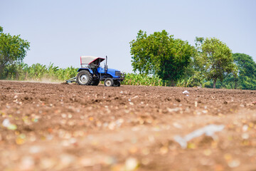 tractor working in the agricultural empty field