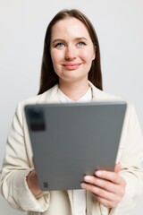 Creative professional engaging with digital technology while smiling warmly, highlighting a moment of inspiration during work hours