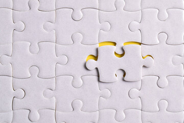 Missing jigsaw puzzle pieces and business concept on yellow background. Completing final task