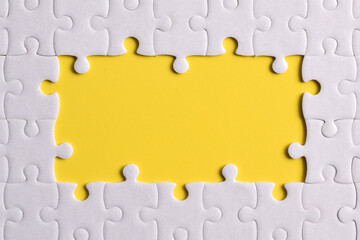 Close up white jigsaw puzzle on yellow background, planning and manage to success business, smart...