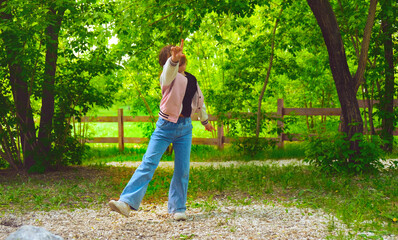 Happy young girl enjoying walking, dancing, jumping. Freedom and carefree. Happy childhood....