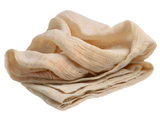 Folded soft light beige muslin cloth against a transparent background