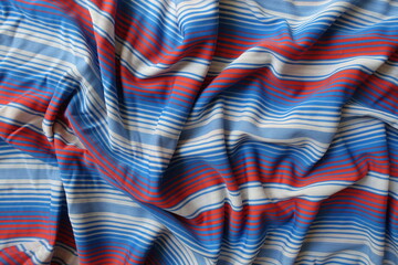 Crumpled blue, red and white striped fabric