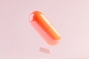 Floating orange capsule on pink background for healthcare design and medical advertisement