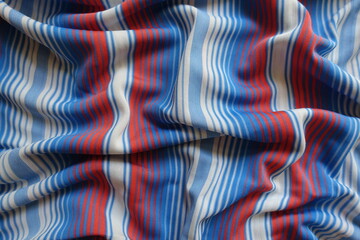 Top view of draped blue, red and white striped fabric