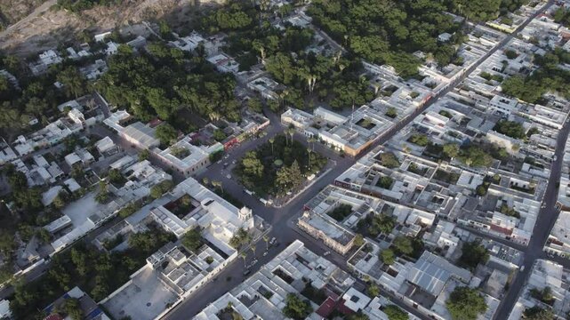 Drone footage at sunrise over Parras de la Fuente, showing urban layout and surrounding terrain under clear sky conditions, captured in stable 4K resolution with smooth tracking and overhead shots.