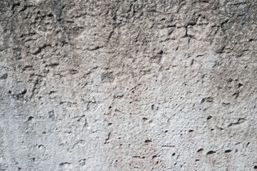 Fototapeta premium rough concrete wall texture close up with cracks and holes aged urban surface detail grunge grey cement background for construction design material architecture or industrial backdrop photography