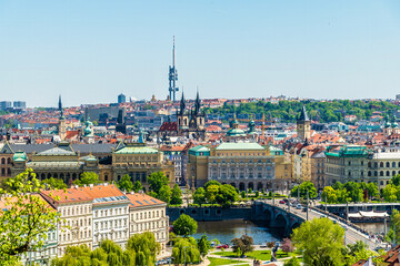 A view from the castle complex towards ornate buildings on the banks of the Vltava river in central Prague in springtime