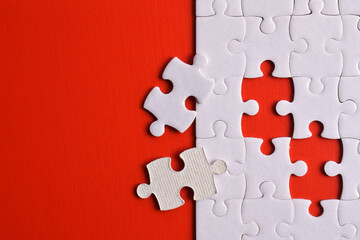 White puzzle with missing piece on red background. Flat lay. Top view