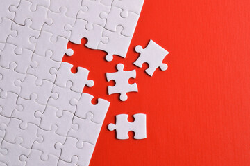White puzzle with missing piece on red background. Flat lay. Top view