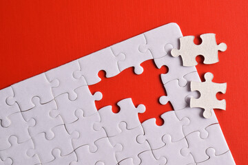 White puzzle with missing piece on red background. Flat lay. Top view