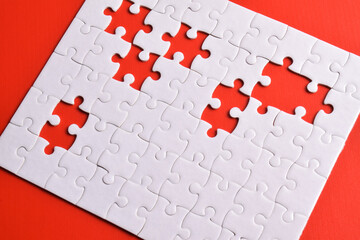 White puzzle pieces on red background. White square puzzle pieces grid. Business background. Top view