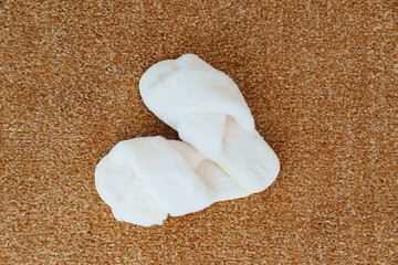 soft white slippers on the beige Interior pile carpet.