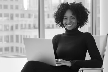 Portrait of successful business black woman in her office, smiling at camera. 
