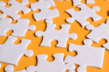 Puzzle background. Puzzle pieces on orange background