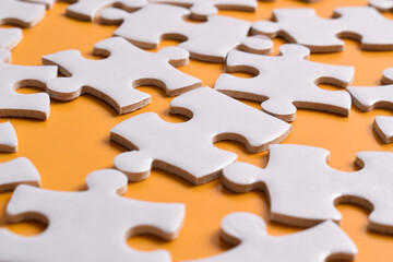 Puzzle background. Puzzle pieces on orange background