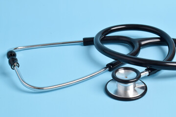 Stethoscope on light blue background, closeup