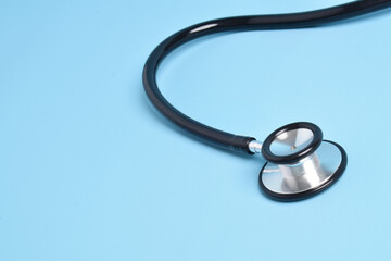 Stethoscope on light blue background, closeup