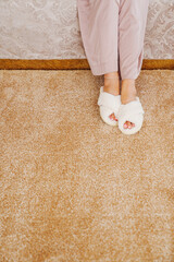 soft white slippers on the beige Interior pile carpet.