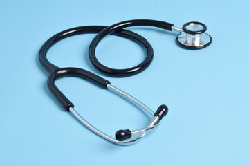 Medical stethoscope on light blue background. Health care concept