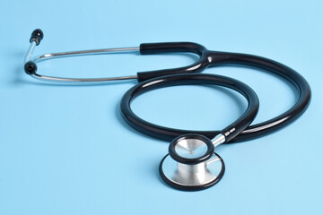 Medical stethoscope on light blue background. Health care concept