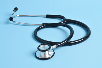 Medical stethoscope on light blue background. Health care concept