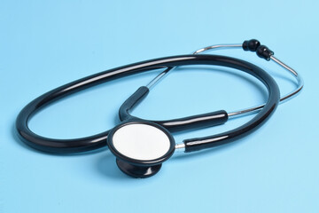 Medical stethoscope on light blue background. Health care concept