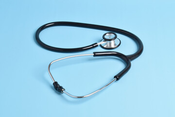 Stethoscope on light blue background. Health care concept