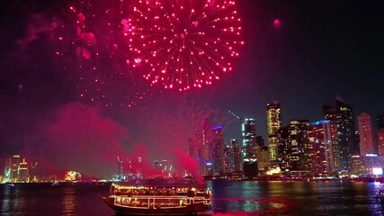 Fireworks display show seen from the water with Dubai skyline in the background at night - Powered by Adobe