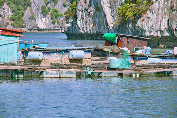 Halong Bay, a UNESCO World Heritage Site, during daytime. A floating village of fishermen.