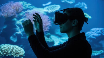 Young male experiencing virtual reality underwater adventure with vr headset and coral reef scene