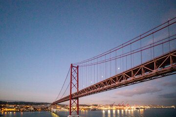 Obraz premium Lisbon Portugal on November 19, 2024. Sunset view of the Tagus River in Lisbon from the deck of a cruise ship departing from the port in Alfama.
