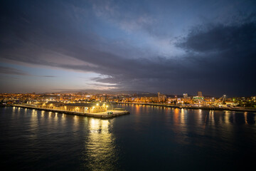 Fototapeta premium Lisbon Portugal on November 19, 2024. Sunset view of the Tagus River in Lisbon from the deck of a cruise ship departing from the port in Alfama.