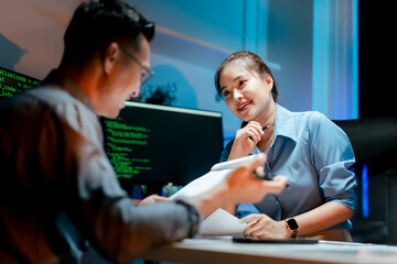 Team of programmers working late at night at a software development company, web developers, and...
