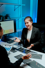 Stock market investors are thinking and analyzing the market trends late at night. Business team,...