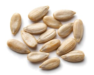 Obraz premium Scattered raw shelled sunflower seeds isolated on a white background