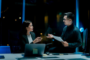 Coworkers work late into the night discussing marketing plans, discussions, suggestions or opinions...